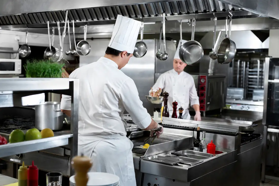 two cooks in commercial kitchen